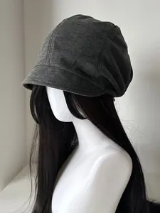 Side profile detail of a dark grey slouchy knitted beret on a mannequin model