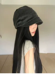 Side view of woman wearing a dark grey vintage pleated slouchy hat with short brim