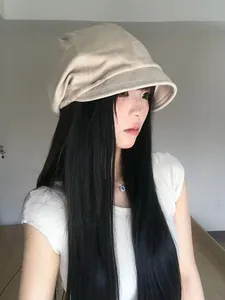 Detailed side view of an Asian woman wearing a stylish pleated beige short brim beanie