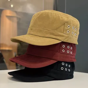 Side view detail of stacked cotton flat top military cadet caps in multiple colors.