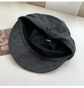 Detailed view showing the soft black inner lining and adjustable drawstring of this grey newsboy cap