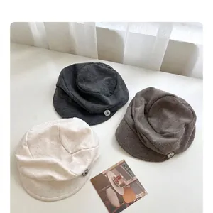 Set of three pleated retro newsboy hats in cream, gray, and brown colors