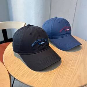 Washed cotton baseball caps featuring unique fish embroidery and slogan for casual wear.