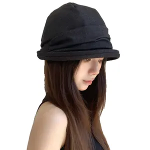 Stylish black pleated bucket hat for women with Korean design and sun protection.
