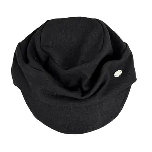 Close-up of black knitted newsboy hat showing retro lazy style and metal logo detail.