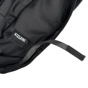 Close-up of black equestrian hat inner lining with brand label and adjustable strap