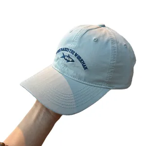 Light blue washed cotton baseball cap featuring unique fish embroidery and WORK text