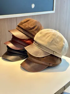 Detail view of stylish suede newsboy caps with PU leather brims in assorted colors