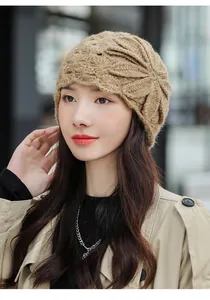 Detailed close-up showing the elegant flower knit pattern on a beige mohair winter beanie