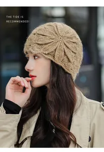 Close-up of elegant beige knitted beanie with large floral mohair texture on model
