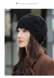 Elegant black mohair knitted beanie with flower design worn by a female model
