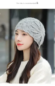 Detailed side view of an elegant grey mohair knit beanie featuring a large flower design