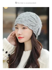 Close-up of an elegant grey crocheted wool beanie featuring intricate flower patterns.