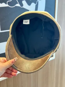Interior detail view of a stylish newsboy hat with faux suede top and PU leather brim