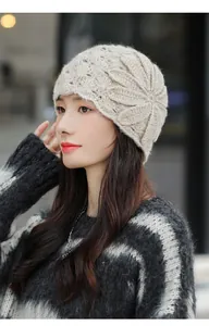 Detailed view of elegant beige mohair knit beanie featuring a large floral crochet pattern