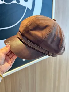 Stylish brown suede newsboy cap featuring a PU leather brim for women's autumn fashion