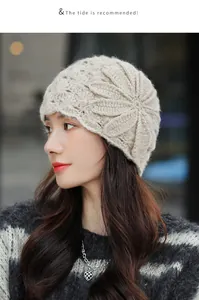 Elegant beige mohair-like knitted beanie with large flower pattern worn by model