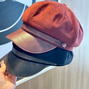 Elegant suede newsboy cap for women featuring a PU leather brim in rust red and black