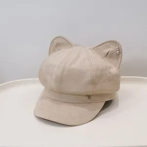 Detailed view of a cute beige newsboy cap featuring decorative cat ears and pearls.