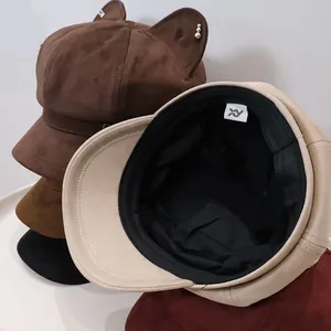 Stack of cute suede cat ear octagonal hats showing interior lining and various colors