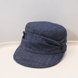 Detailaufnahme einer dunkelblauen Denim-Schirmmütze mit stilvollen Seitenfalten