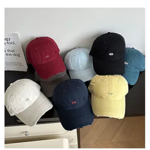 Detailed macro view showing variety of multicolored distressed embroidered baseball caps.