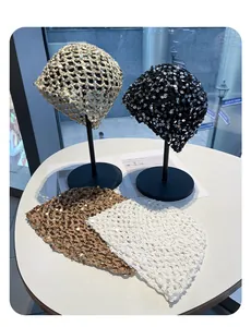 Close-up view of hand-woven vintage sequined knitted hats in multiple colors on display.