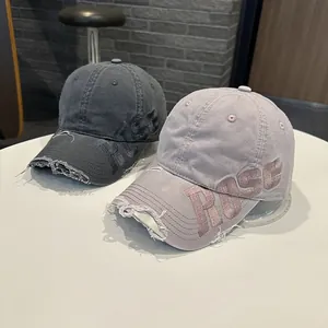 Vue détaillée de deux casquettes de baseball vintage en coton lavé avec broderie ROSE