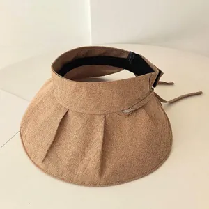 Macro view showing the high-quality textured brown fabric and pleated brim of this sun visor.