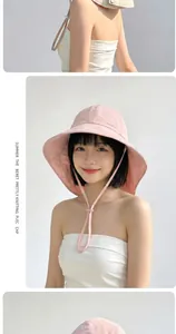 Detailed view of pink breathable cotton linen sun hat with wide brim and adjustable strap