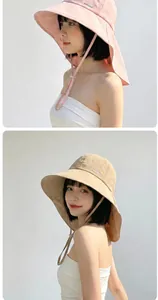 Detailed view of women's breathable wide brim sun hats in pink and khaki colors