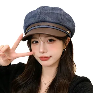 Stylish women's denim patchwork newsboy cap with brown leather brim for winter.