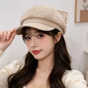 Close-up of a stylish beige newsboy hat featuring cute fox ears and a key charm