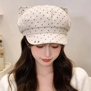 Close-up of a retro polka dot newsboy cap with cute cat ears and metal rings