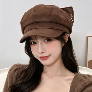 Close-up of a vintage brown beret hat with cute fox ears and metal charms