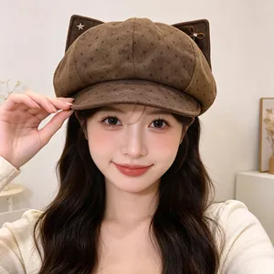 Front view of a brown vintage polka dot newsboy hat with cute cat ears decoration.