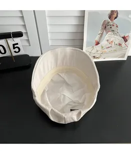 Vue détaillée de la doublure de la casquette beige avec tissu blanc et bande de confort.