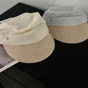 Stylish pleated fabric and straw sun hat with wide brim for summer sun protection.