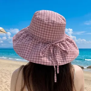 Elegant pink plaid bucket hat with wide brim for sun protection during beach trips