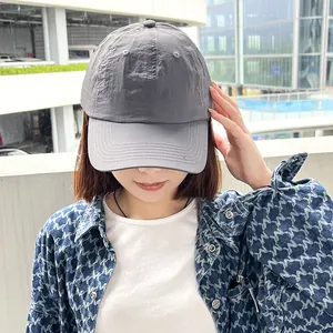 Detail view of the gray quick-drying soft top baseball cap for women in an outdoor setting