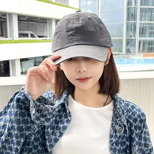 Close-up view of a women's gray quick-dry sports baseball cap worn by an Asian model