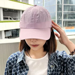 Close-up of a lavender quick-dry baseball cap for women in a sunny outdoor setting