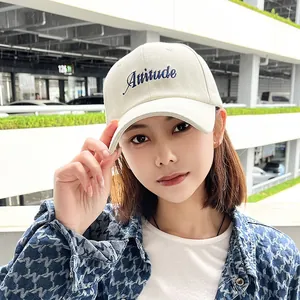 Classic beige minimalist baseball cap with blue Attitude embroidery and wide brim design