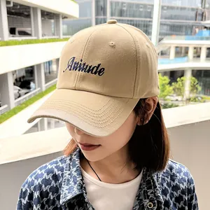 Stylish khaki cotton baseball cap with Attitude embroidery on an Asian female model