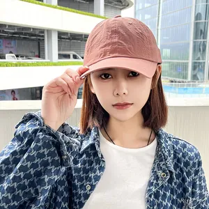 Detailed view of a premium pink quick-dry soft top baseball cap worn by a model.