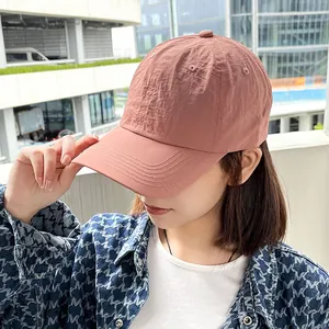 Detail view of a pink quick-dry baseball cap for women featuring a soft top and curved brim