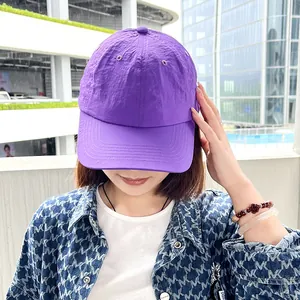 Close-up of a women's purple quick-dry soft top baseball cap for outdoor sun protection