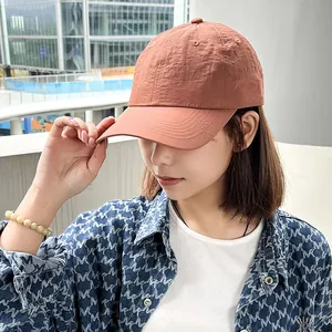 Detail shot of woman wearing a breathable quick-dry baseball cap in peach color