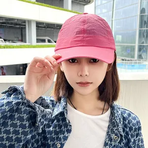 Close-up of pink quick-dry sports baseball cap with crinkle texture on a model