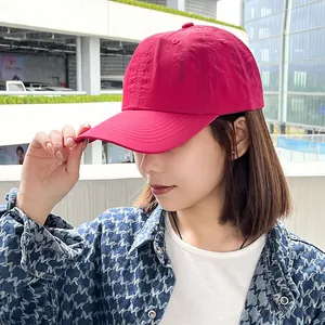 Close-up view of a pink lightweight quick-dry baseball cap for women worn outdoors.